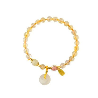 Gold rutilated quartz crystal bracelet with geometric peace buckle pendant and safety clasp