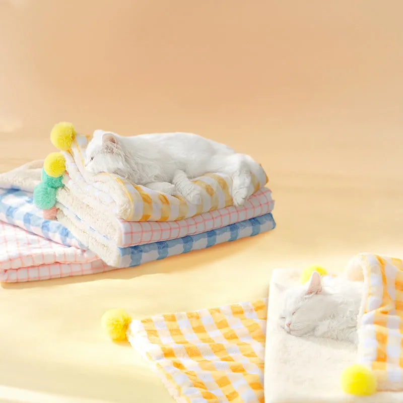 A blue coral fleece pet blanket laid flat, showing its soft texture and rectangular shape as a dog or cat bed mat.