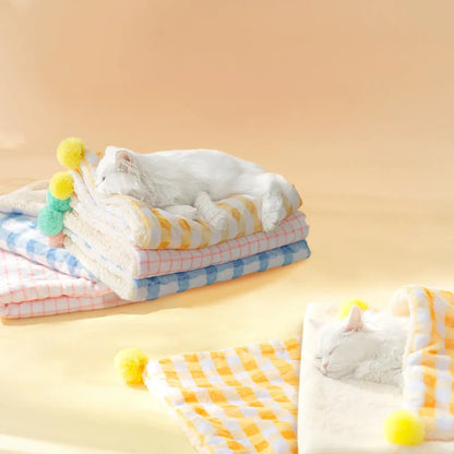 A blue coral fleece pet blanket laid flat, showing its soft texture and rectangular shape as a dog or cat bed mat.
