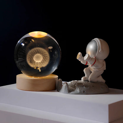 Cosmos Series crystal ball night light with wooden base and astronaut figure, showing Milky Way light pattern