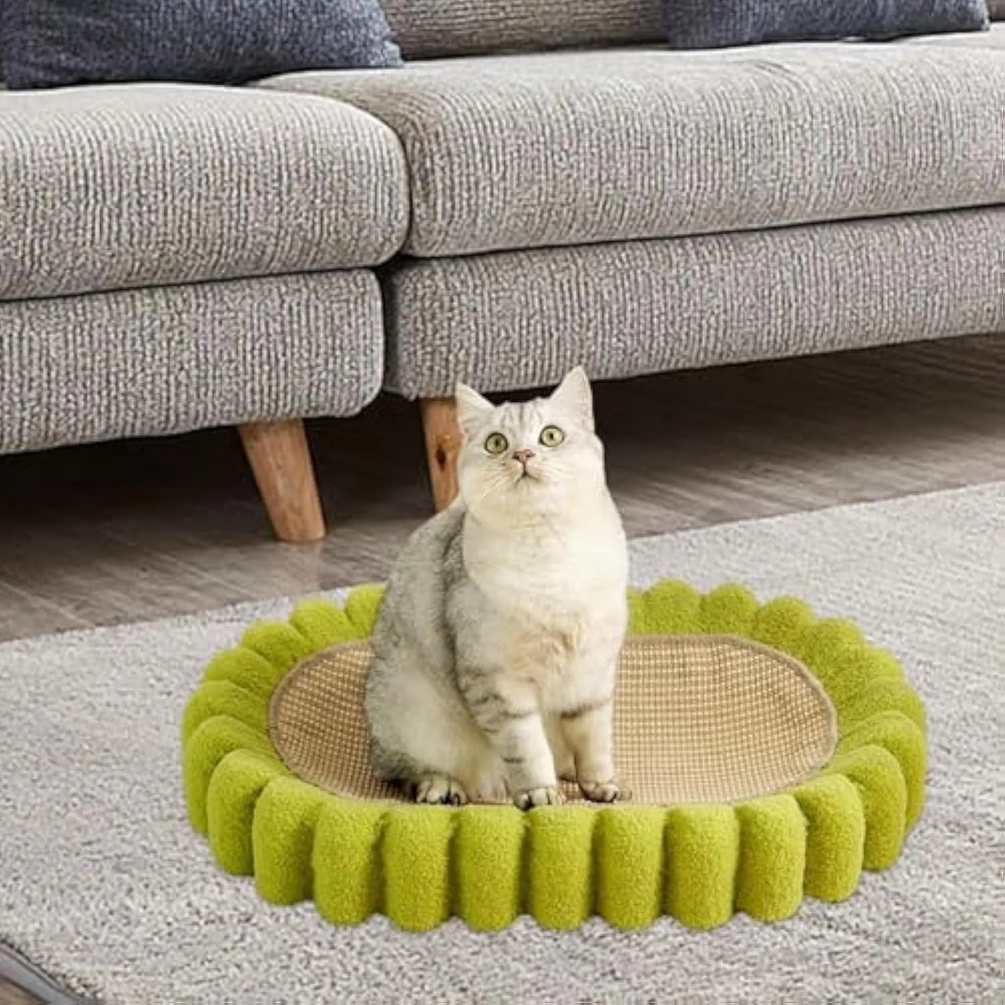 Green oval-shaped sisal cat scratching pad with a deep centre bowl for use as a cat bed.