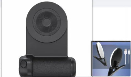 Black magnetic phone camera grip with rotatable bracket and ergonomic PU leather handle on a table.