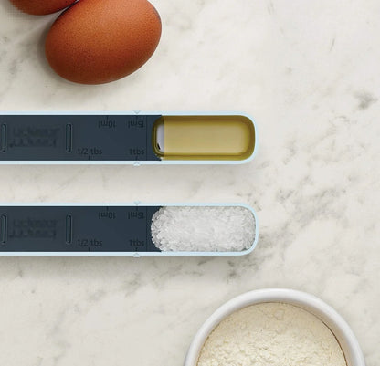 Adjustable 12-speed measuring spoon in grey, perfect for precise kitchen measurements