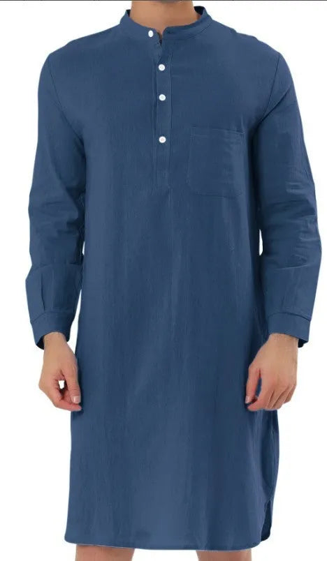 Man wearing a dark blue cotton shirt robe with button front, long sleeves, and side pockets.