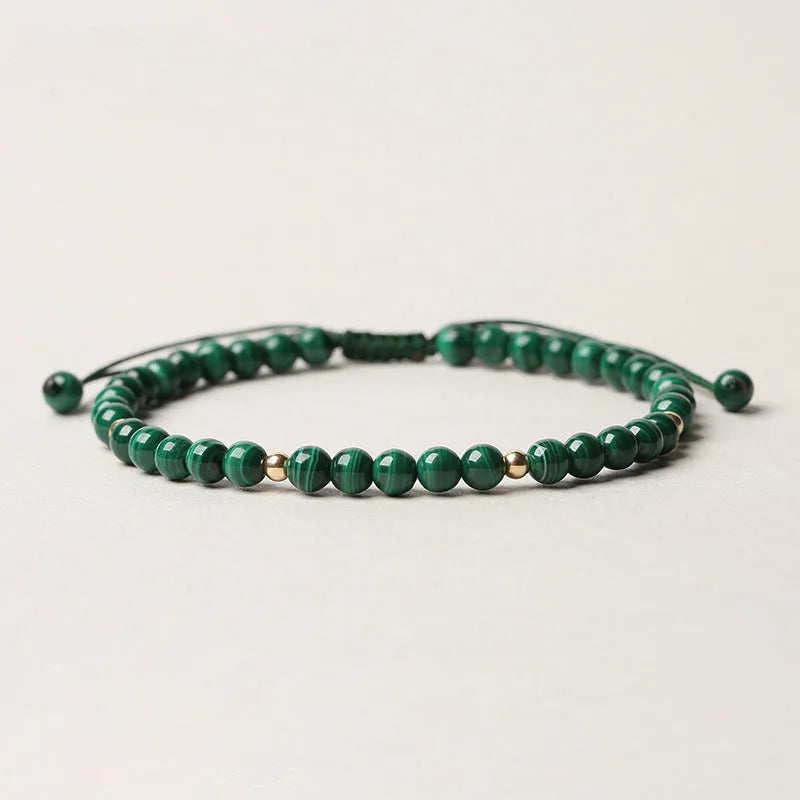 Natural Malachite crystal bracelet for women, a handwoven green malachite stone bracelet with golden ball accents, animal or zodiac-themed bead detailing, a textured statement piece that's manually processed for individual character