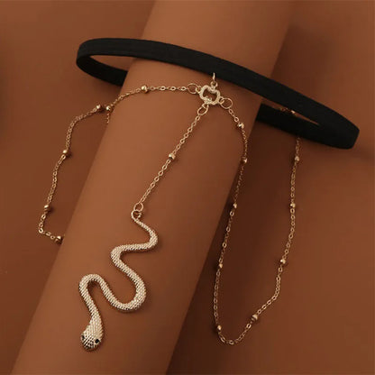 Gold colour alloy thigh chain with big snake pendant and beaded geometric leg chain design