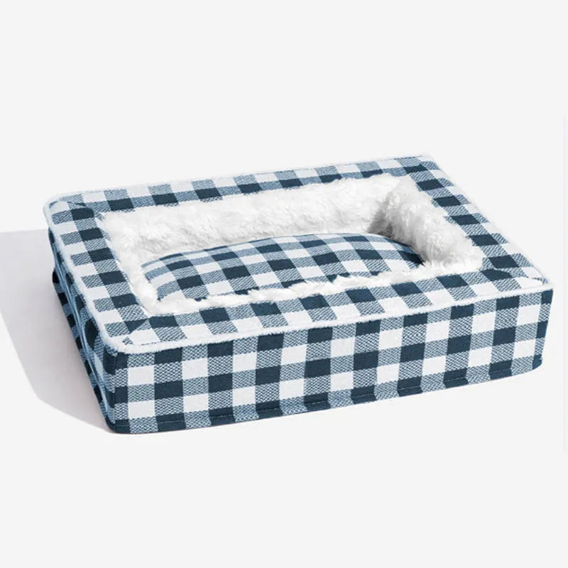 Classic red plaid dog bed cushion with a removable cover, shown in a large size next to a dog crate.