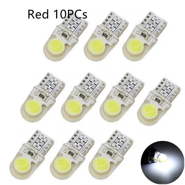 Pack of ten T10 wedge base LED car bulbs with COB chips in various colours on a white background