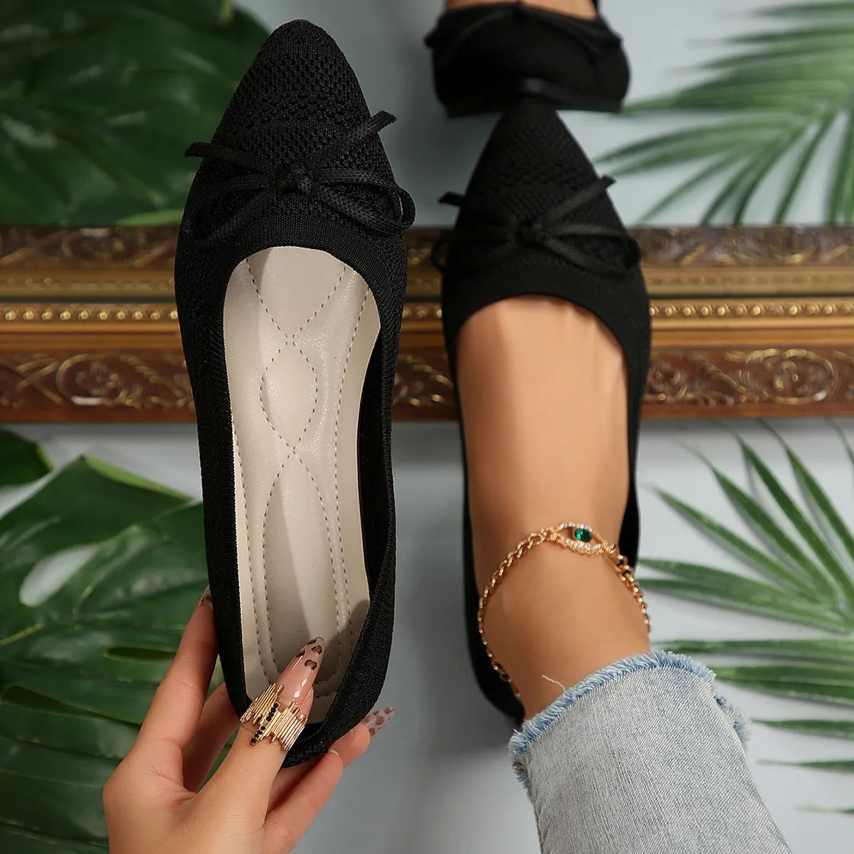 Women's blue knitted loafer flat shoes with a pointed toe and decorative bow detail on the front.