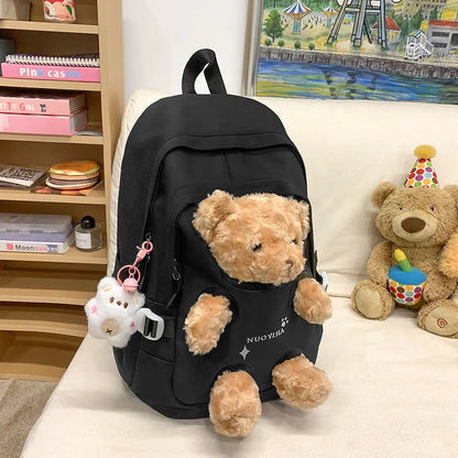 Macaron colour nylon school backpack with curved straps, shown in yellow pink, with a pendant attached.