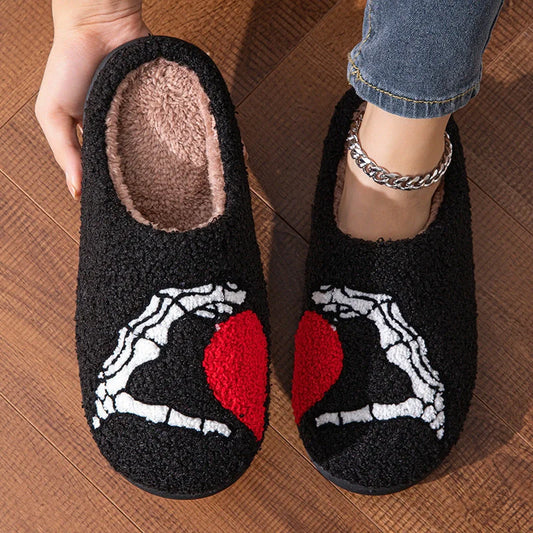 Halloween-themed skull-hand slippers in black and white, featuring non-slip soles for indoor comfort.