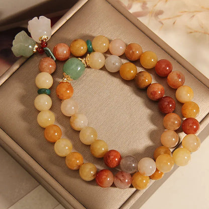 Natural green jade multi-strand bracelet with a silver-ton orchid charm for women.