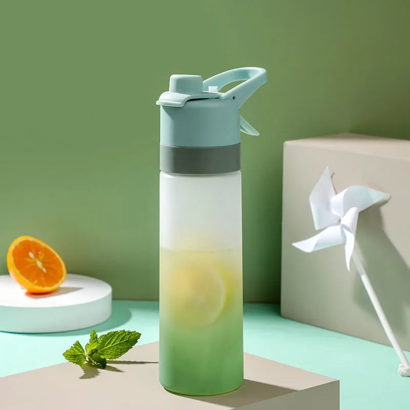 White spray water bottle with black leakproof lid and handle strap on a table