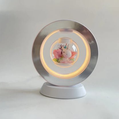 Pink rose eternal flower floating in magnetic levitation LED night light with triangular base and touch control