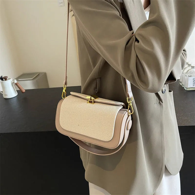 Women's PU leather messenger bag in a horizontal square shape with a lock and adjustable shoulder strap.