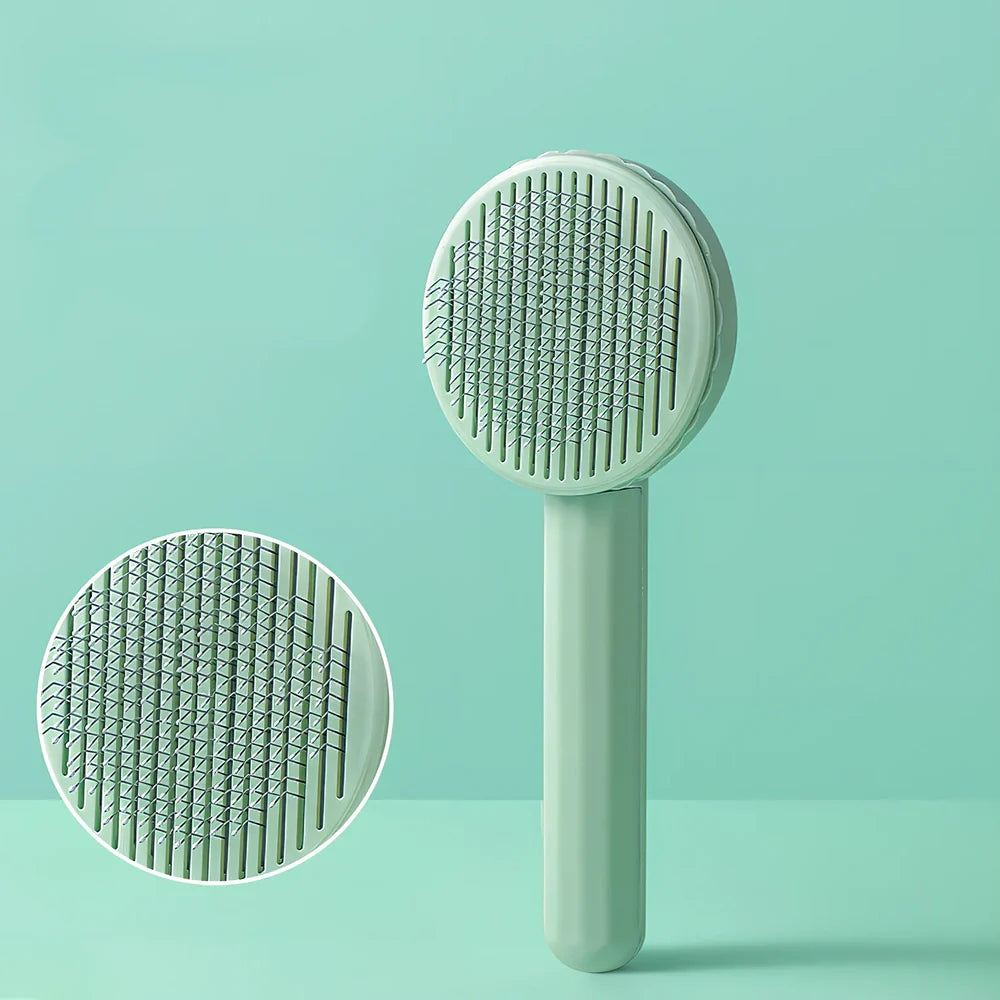 Self-cleaning cat comb with floating needle teeth and built-in hair storage chamber in assorted colours
