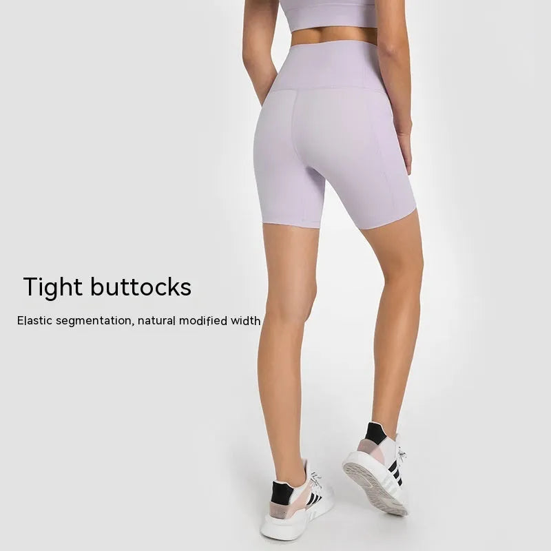 Women's tight-fitting cotton blend sports shorts in black, showing super stretch function and fifth pants length.