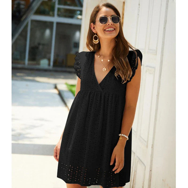 Chic cotton mini dress with floral embroidery and v-neck design for a romantic, summer-ready look