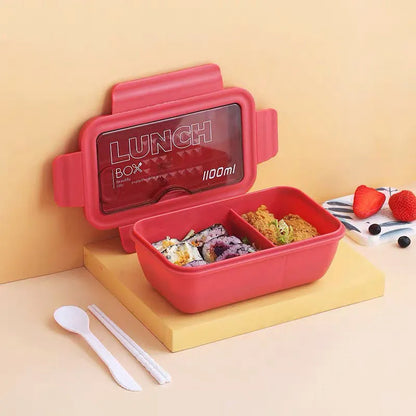 Green four-layer stacked plastic bento box with separate compartments for food, shown next to red and yellow options.