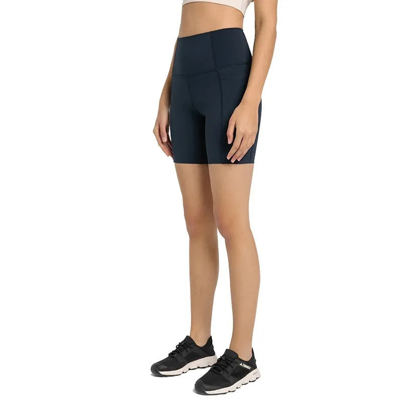 Women's tight-fitting cotton blend sports shorts in black, showing super stretch function and fifth pants length.