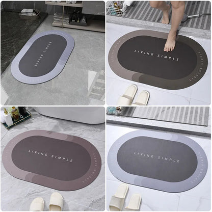 Oval grey bath mat with non-slip rubber bottom on a tiled floor, showing absorbent fabric surface