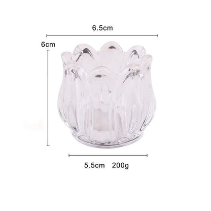 Transparent glass tulip candle holder with classic tumbler base on table