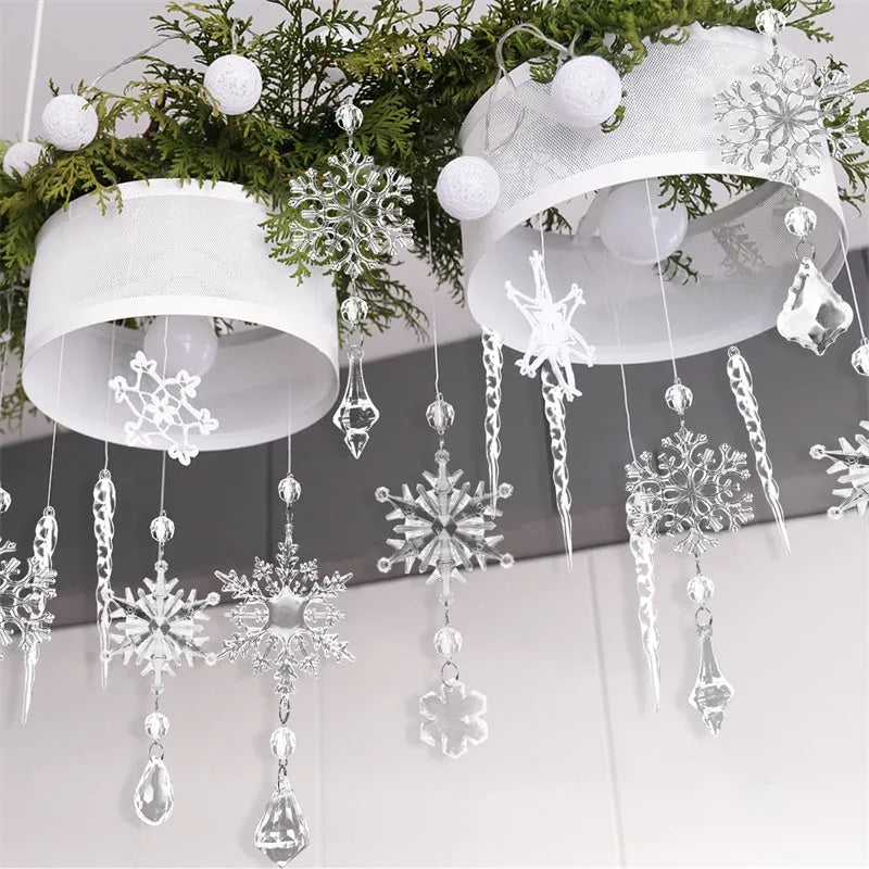 Set of ten clear acrylic icicle-shaped Christmas tree ornaments with white ribbons on green pine branches.