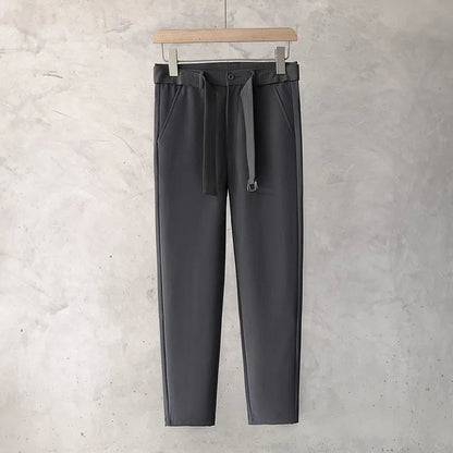 Boys slim straight wool trousers in tapered fit on hanger, showing straight leg opening.
