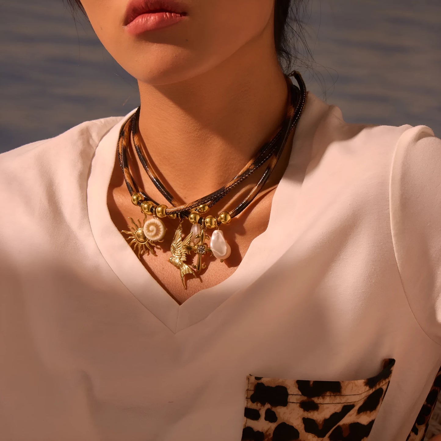 Women's stainless steel necklace with geometric leopard pendant, gold electroplated, on an adjustable chain.