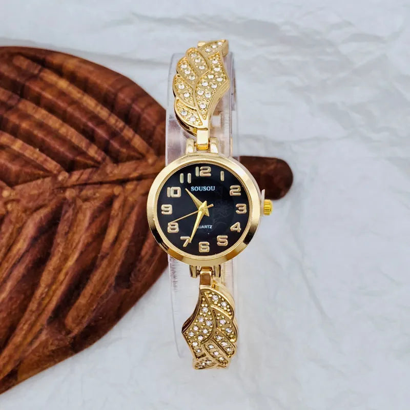 Stainless steel women's watch with round dial and vachette clasp on wrist.