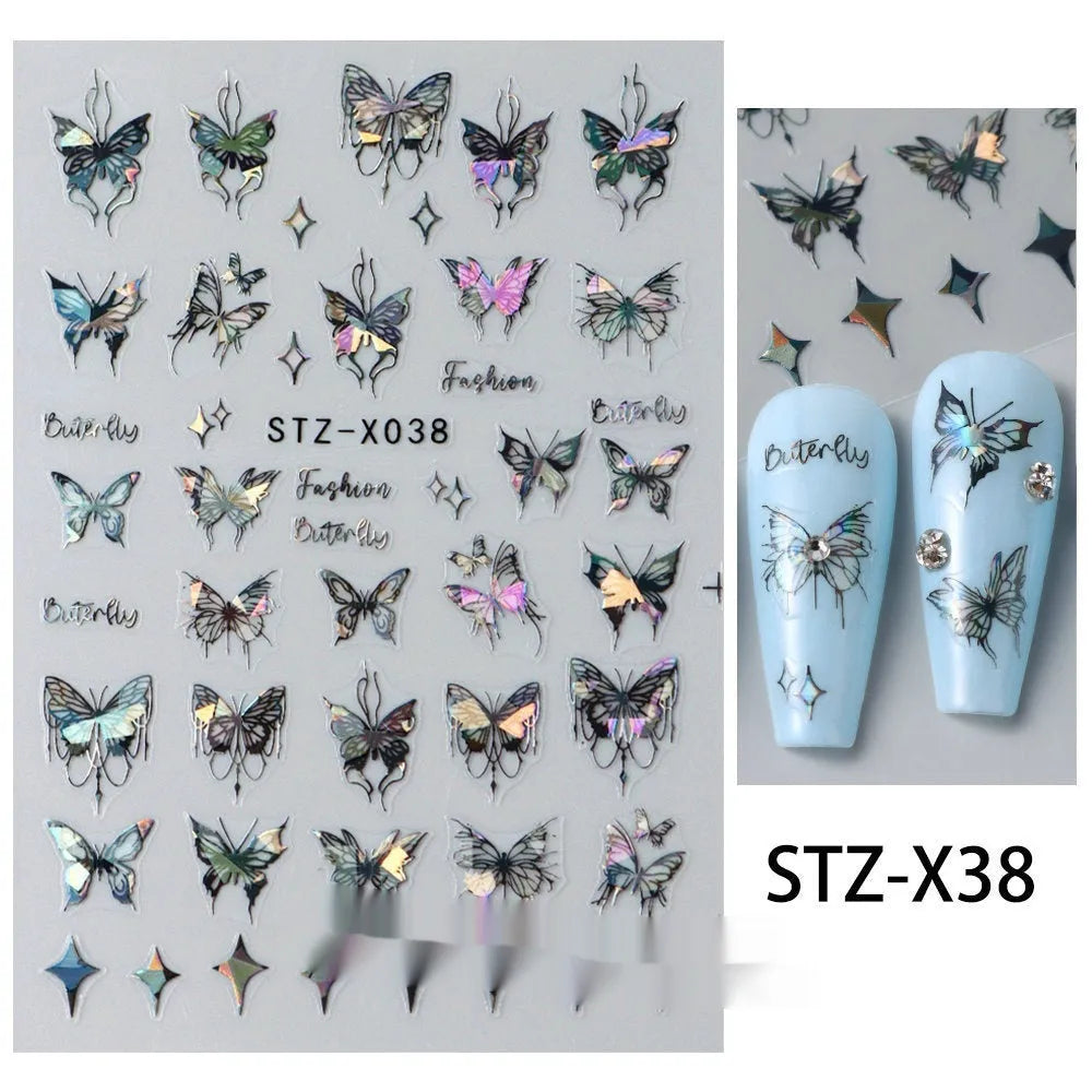 Assortment of black and silver nail sticker designs including cartoon and French tip patterns on a plastic sheet.