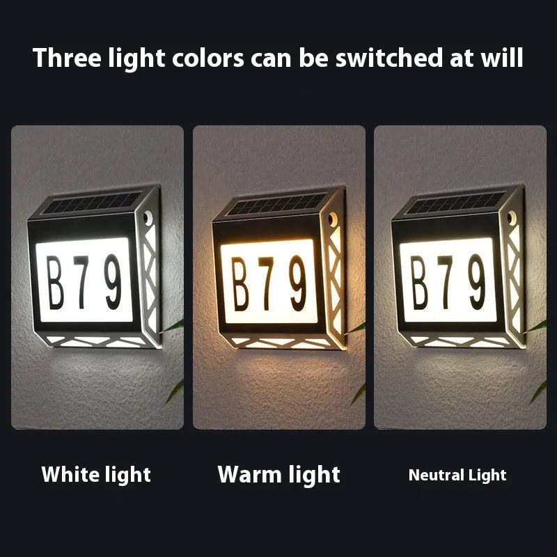 Black solar doorplate light with LED illumination showing house numbers