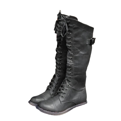 Women's black knight ankle boots with cross straps and buckles over lace-up front.