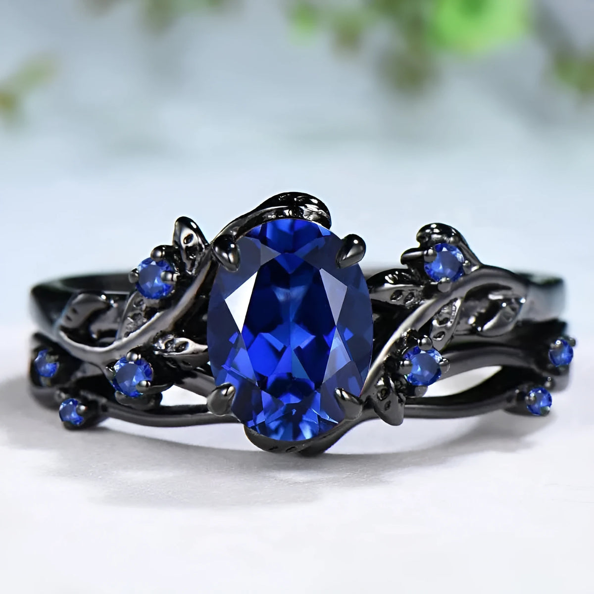 Geometric black women's couple ring with navy blue rhinestone inlay showing side profile