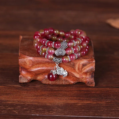 Handmade bracelet with green and pink watermelon crystal beads tied with Chinese knots.