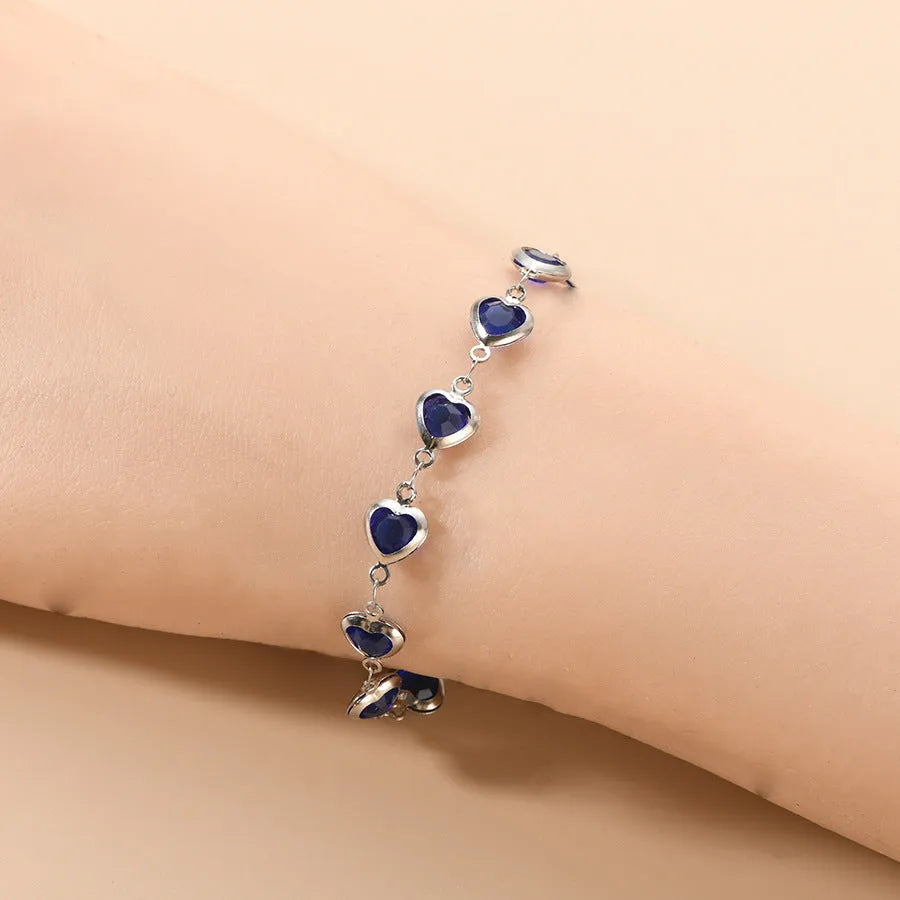 Devil's eye geometric heart bracelet in stainless steel showing colourful electroplated finish options.