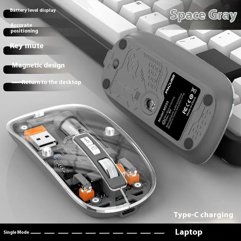 Transparent wireless computer mouse in blue on a desk next to a laptop