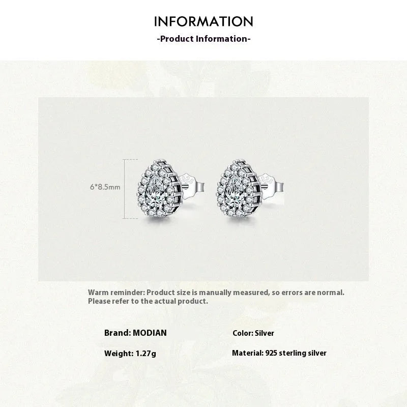 A pair of drop-shaped sterling silver ear studs with a diamond-cut finish.