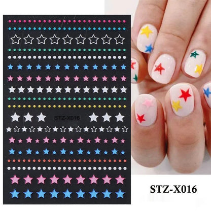 Assortment of black and silver nail sticker designs including cartoon and French tip patterns on a plastic sheet.