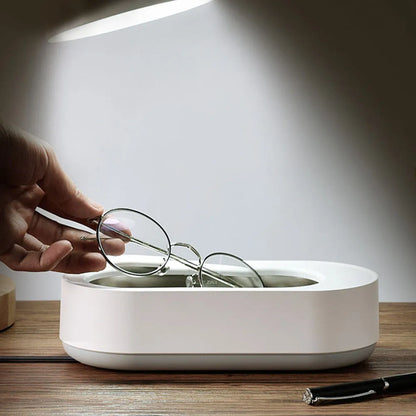 White portable ultrasonic cleaner with stainless steel tank for cleaning jewellery and glasses.