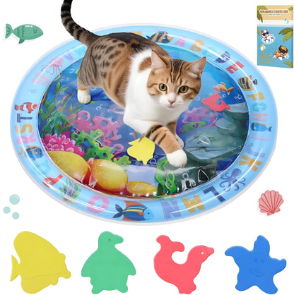 Blue ocean-themed cat water play mat with floating fish toys inside an inflated square border on a wooden floor.