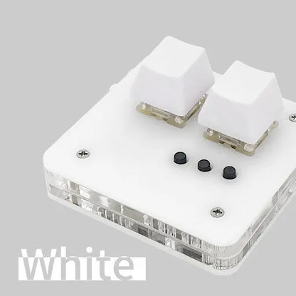 Mini USB wired keyboard in white, light grey, black, or pink colour on a desk.