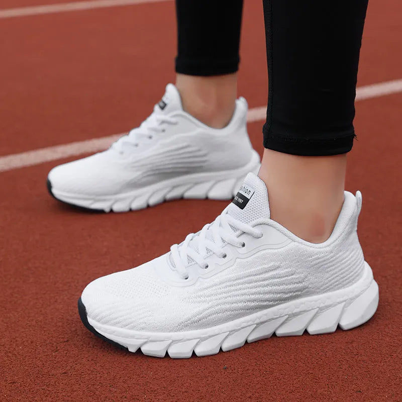 Women's black and white low-top casual running sneakers with round toe and MD soles