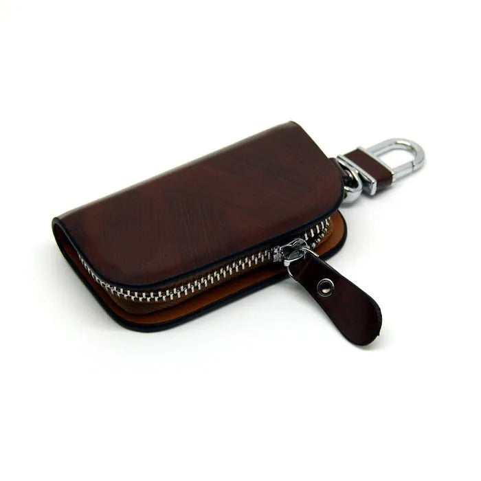 Genuine leather car key case with zipper closure showing black and brown colour options