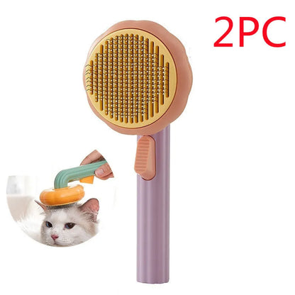 Hand-held pumpkin-coloured pet brush with stainless steel needles for grooming cats and dogs