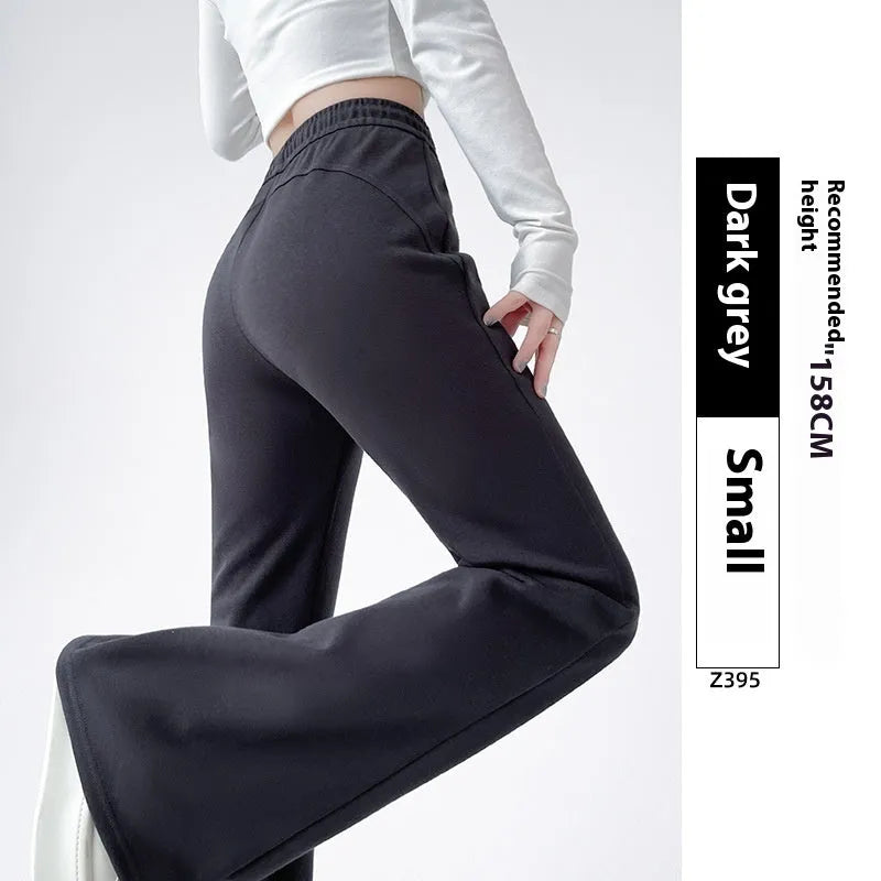 Women's high waist bootcut sports pants in black cotton with fleece lining and micro elasticity, slightly flared leg.