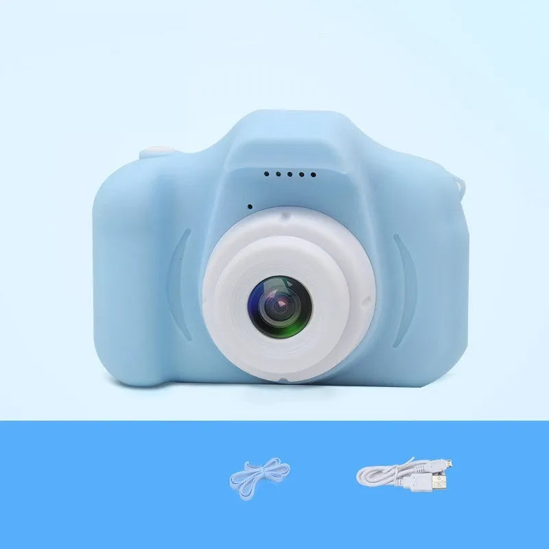 X2 HD mini digital camera for kids in silicone case with lanyard, shown capturing photo on 2-inch screen.