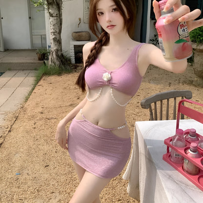 Pink and black polyester three-piece bikini swimsuit on a mannequin