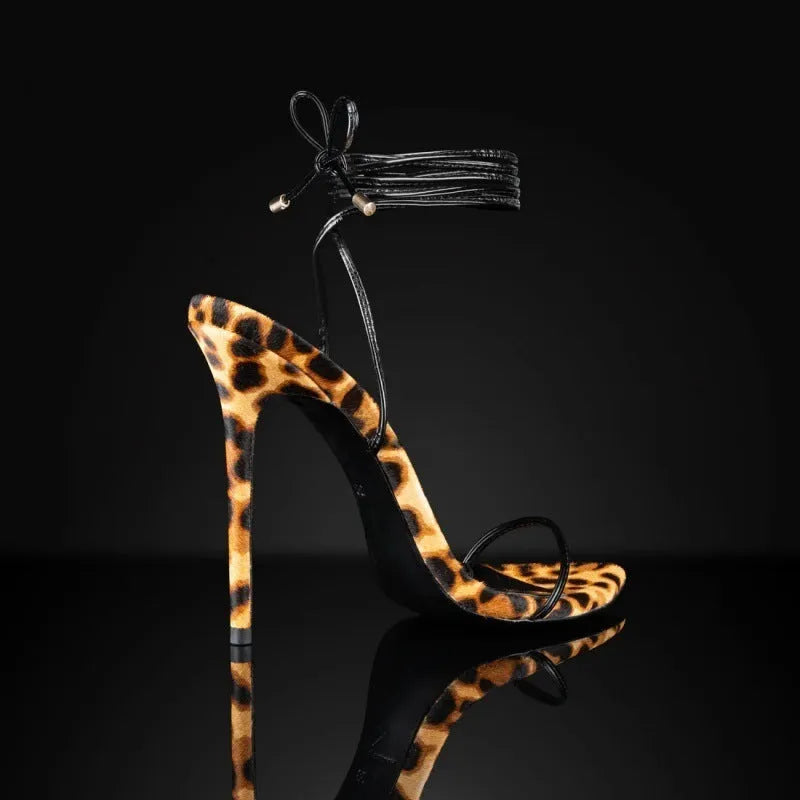 Leopard print women's Roman sandals with pointed toe and lace-up buckle closure on a rubber sole