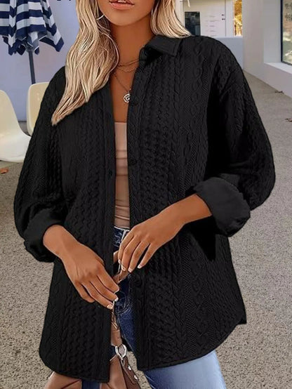 Women's solid colour long-sleeved cardigan sweater in black, shown in a commute-style setting.
